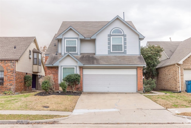 traditional-style house with a front lawn, brick siding, a garage, and driveway