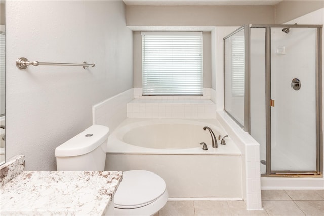 full bathroom with vanity, tile patterned flooring, a shower stall, a garden tub, and toilet