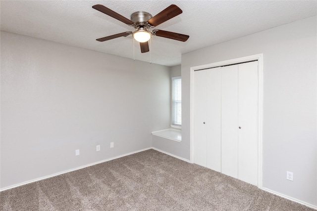 unfurnished bedroom with a closet, carpet floors, a textured ceiling, and ceiling fan