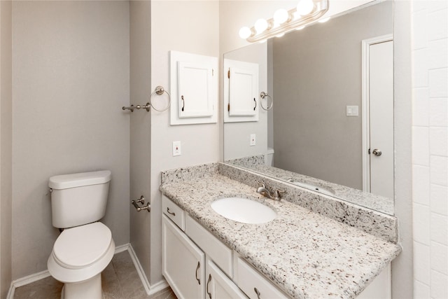 bathroom featuring tile patterned floors, toilet, vanity, and baseboards