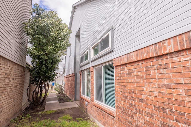 view of side of home with brick siding