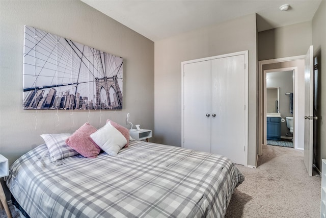 carpeted bedroom featuring a closet and baseboards