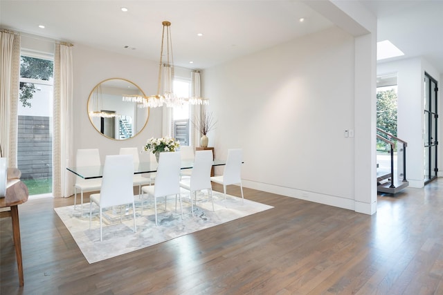 dining area with a notable chandelier, recessed lighting, and wood finished floors