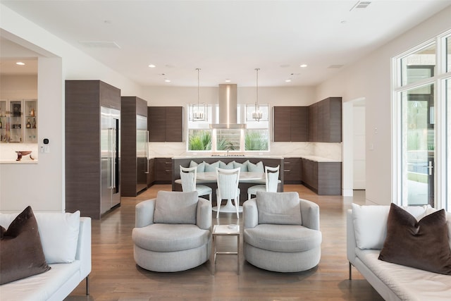 living room with recessed lighting, a healthy amount of sunlight, and light wood finished floors