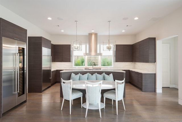 dining space with an inviting chandelier, recessed lighting, and dark wood-style flooring