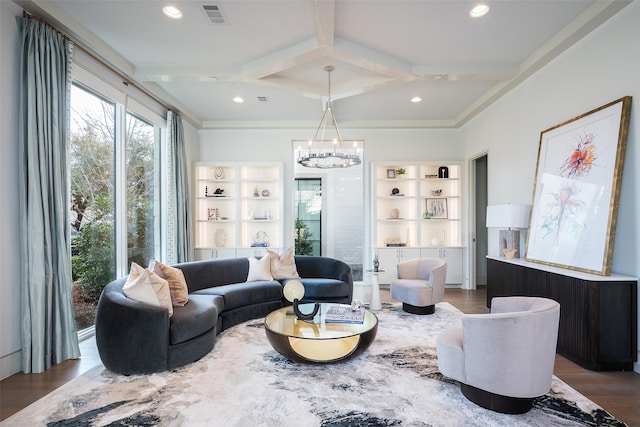 living area with visible vents, beam ceiling, coffered ceiling, wood finished floors, and an inviting chandelier