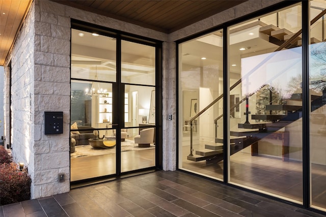 wine room featuring a notable chandelier, wood ceiling, and dark wood-style flooring