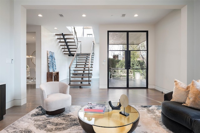 living area featuring visible vents, recessed lighting, stairs, and wood finished floors