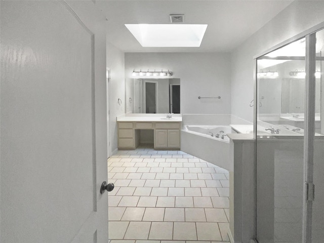 bathroom featuring visible vents, a skylight, tile patterned flooring, a bath, and vanity