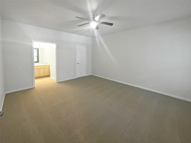 interior space featuring light colored carpet, baseboards, and ceiling fan