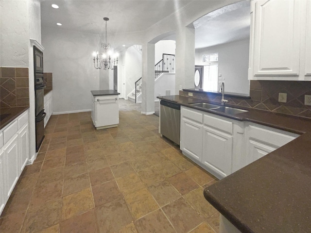 kitchen featuring a sink, white cabinets, dishwasher, dark countertops, and backsplash