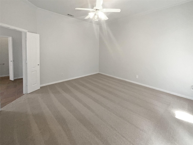 unfurnished bedroom featuring a ceiling fan, visible vents, carpet, and baseboards