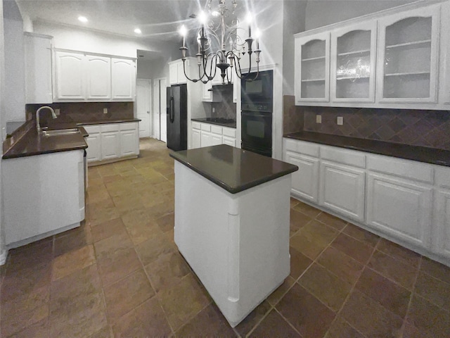 kitchen with a sink, decorative backsplash, dark countertops, and black appliances