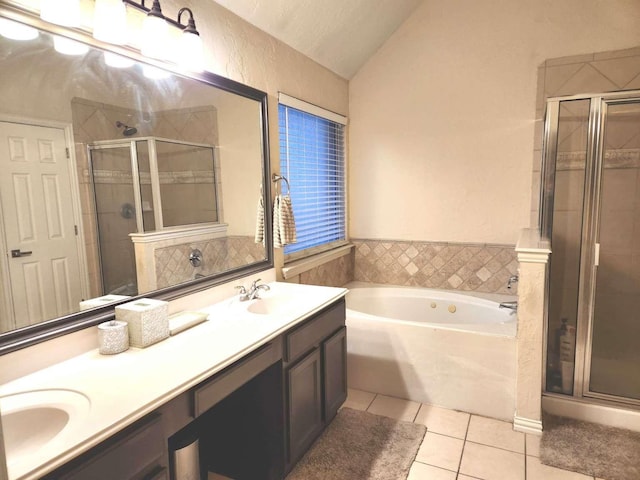 full bath with tile patterned flooring, lofted ceiling, double vanity, and a stall shower