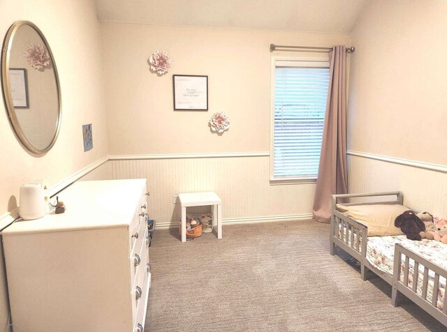 bedroom with carpet flooring and wainscoting