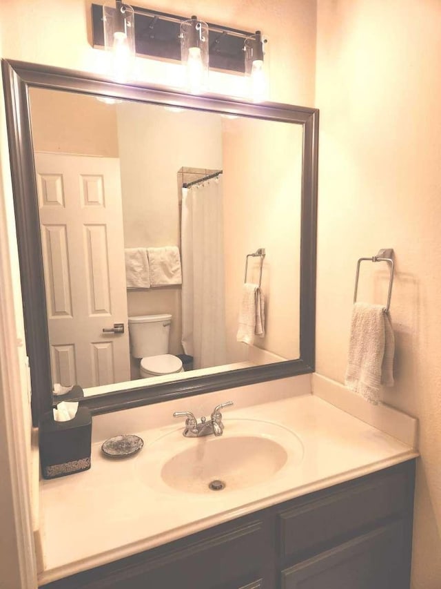 bathroom featuring vanity and toilet