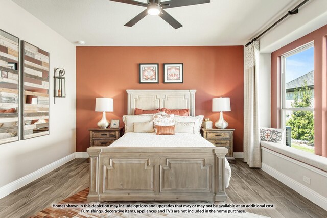 bedroom featuring wood finish floors, baseboards, multiple windows, and ceiling fan