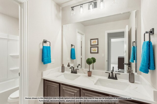 full bathroom with double vanity and a sink