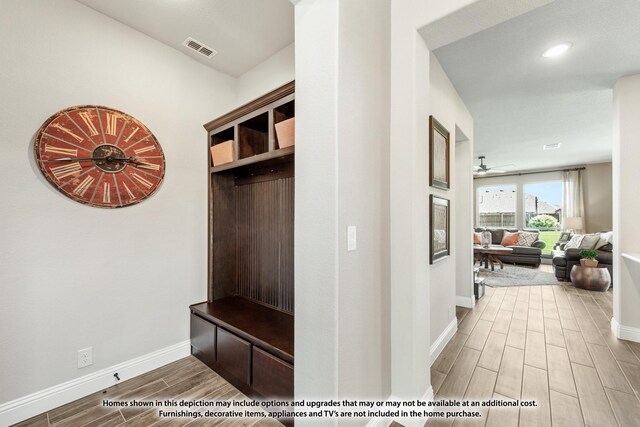 mudroom featuring wood finish floors, visible vents, baseboards, and ceiling fan