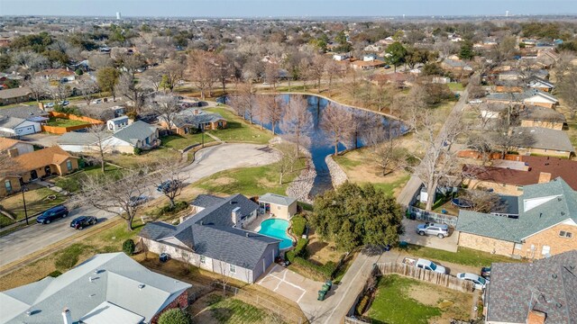 drone / aerial view featuring a residential view and a water view