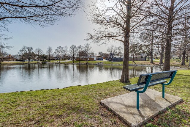 view of community featuring a yard and a water view