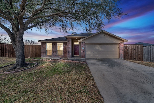 single story home with an attached garage, fence, brick siding, and driveway