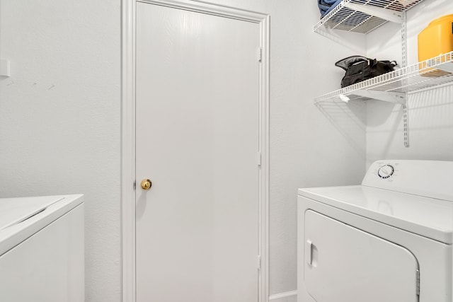 clothes washing area with laundry area and washing machine and clothes dryer