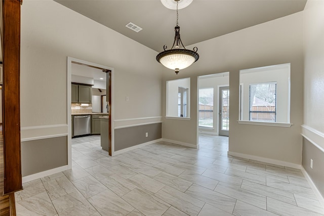 unfurnished room with visible vents and baseboards