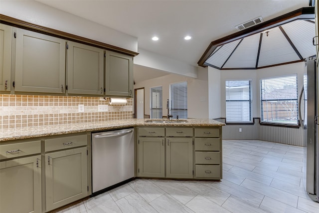 kitchen with a wainscoted wall, visible vents, a peninsula, a sink, and appliances with stainless steel finishes