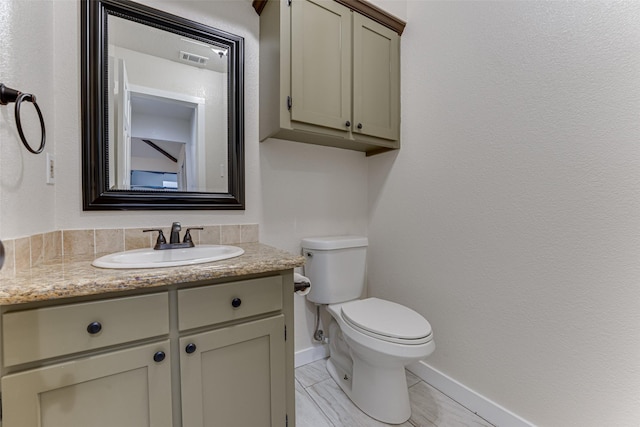 bathroom with visible vents, baseboards, toilet, and vanity