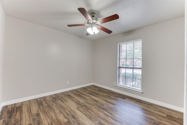 unfurnished room featuring ceiling fan, baseboards, and dark wood finished floors