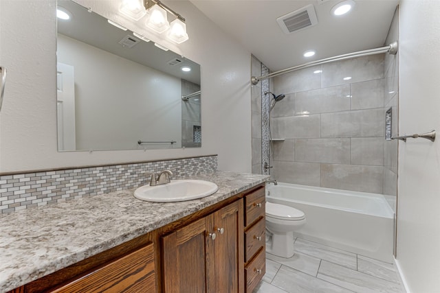 full bath with vanity, toilet, tasteful backsplash, and visible vents