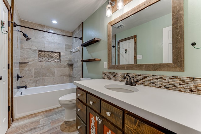 bathroom with visible vents, toilet, wood finished floors, decorative backsplash, and vanity