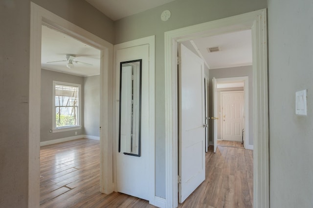 hall featuring baseboards and wood finished floors