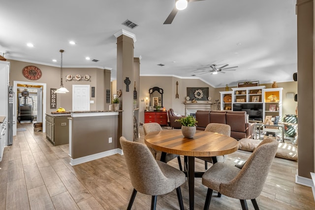 dining room with visible vents, ceiling fan, light wood-type flooring, and ornate columns