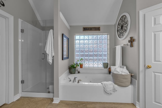 bathroom featuring crown molding, a tub with jets, and a stall shower