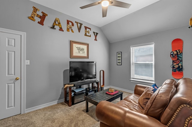 living area with baseboards, lofted ceiling, carpet, and ceiling fan