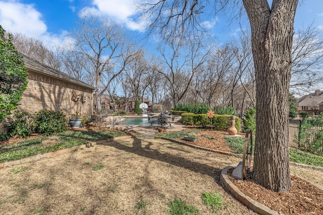 view of yard with a fenced in pool, a patio, and fence