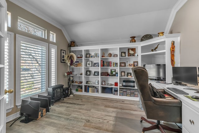 home office with wood finished floors, crown molding, and vaulted ceiling