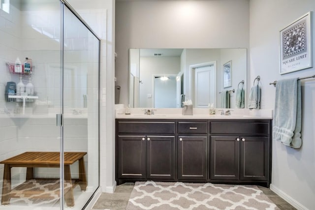 full bath with a sink, a stall shower, visible vents, and double vanity