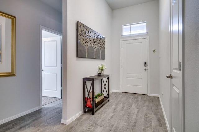 entrance foyer with light wood-type flooring and baseboards