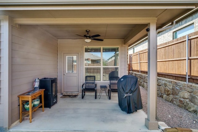 view of patio / terrace with area for grilling, a ceiling fan, and fence