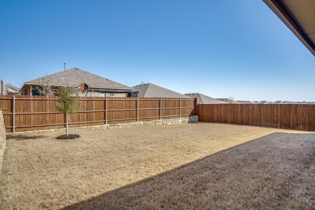 view of yard with a fenced backyard