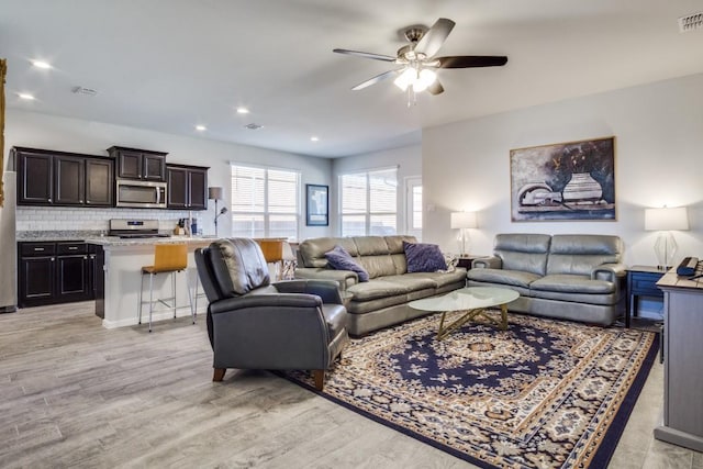 living area featuring recessed lighting, light wood-type flooring, visible vents, and ceiling fan