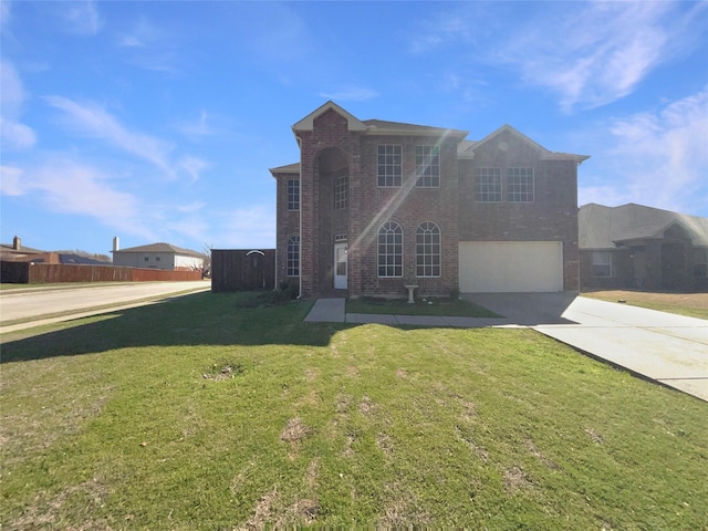 traditional home with brick siding, concrete driveway, a garage, and a front yard