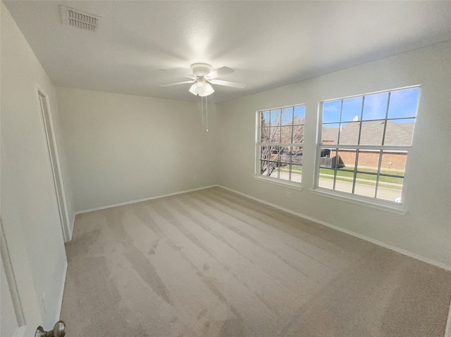 unfurnished room featuring visible vents, baseboards, carpet, and a ceiling fan