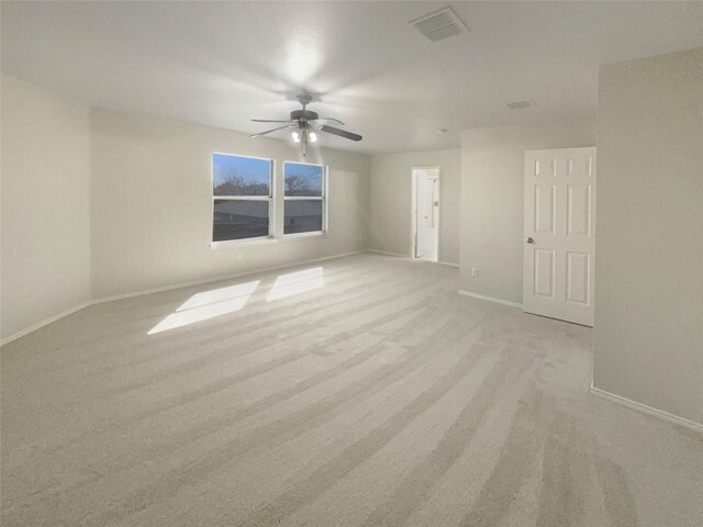 spare room featuring a ceiling fan, baseboards, and visible vents