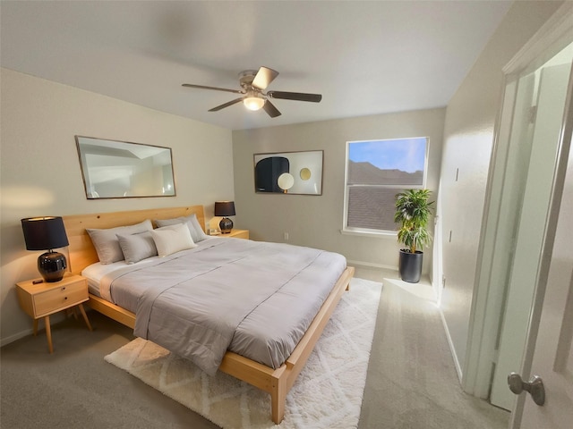 bedroom with baseboards, carpet, and ceiling fan