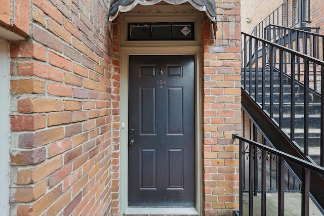 view of exterior entry with brick siding