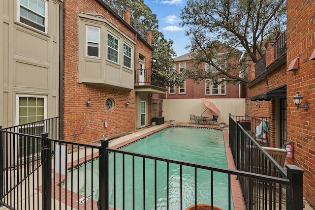 view of pool with central air condition unit, a fenced in pool, and fence